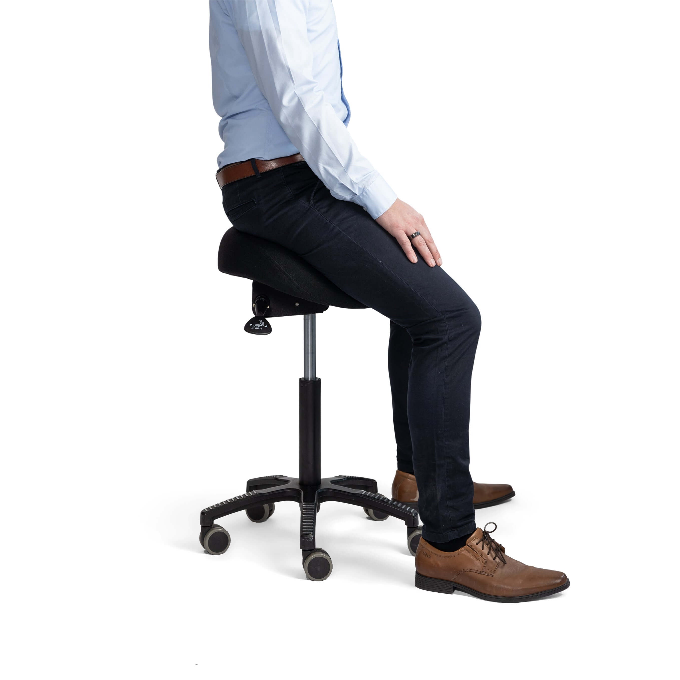 Man sitting on soft saddle chair with black fabric upholstery, showcasing ergonomic design and adjustable seat tilt.